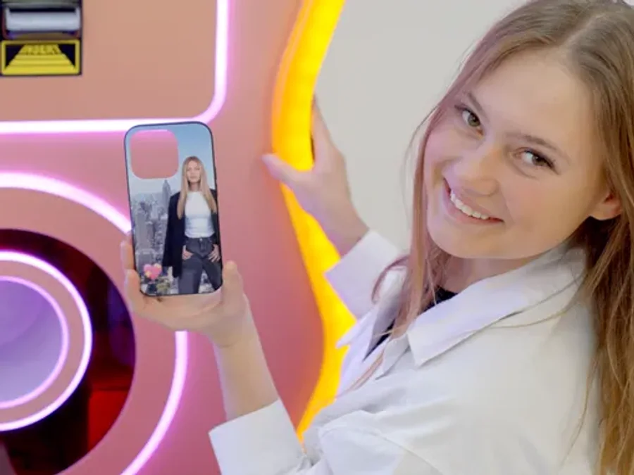 A customer holding the custom phone case she just designed and printed on the Sweet Robo Case BOT